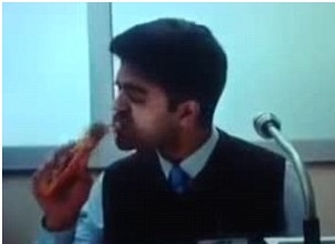 Indian man eating Cadbury PICNIC